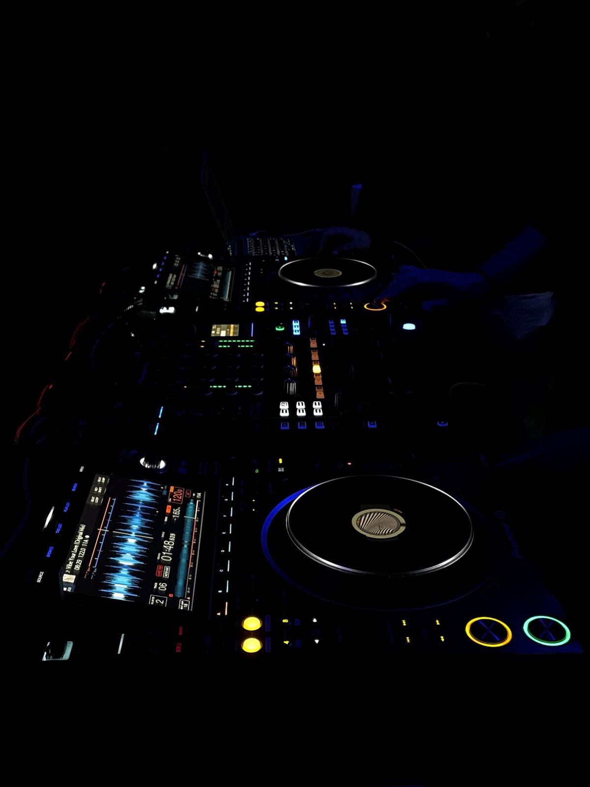 DJ decks glowing in the dark